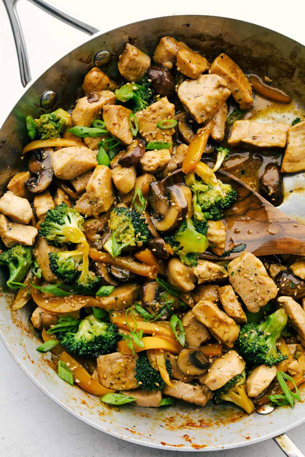 Chicken Garlic stir fry in the pan with broccoli and mushrooms. 