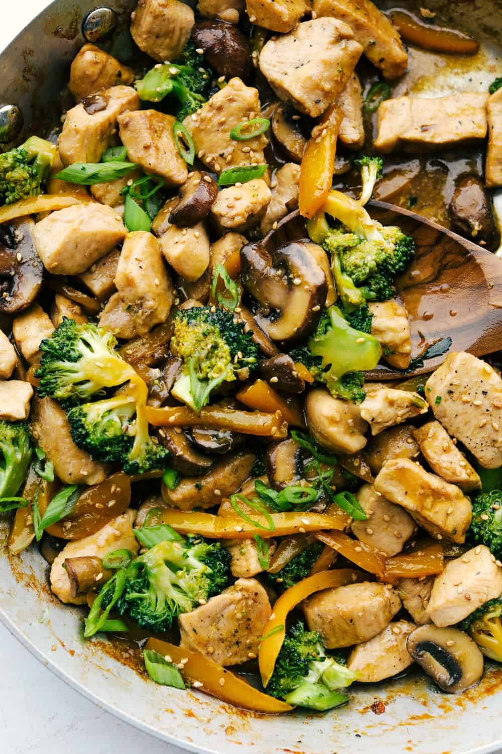 Stirring the chicken, broccoli and mushrooms all together. 