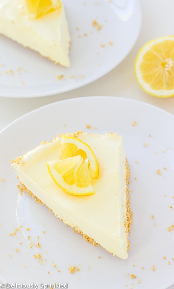 No-Bake Lemon Pie on a white plate with lemon slice for garnish.