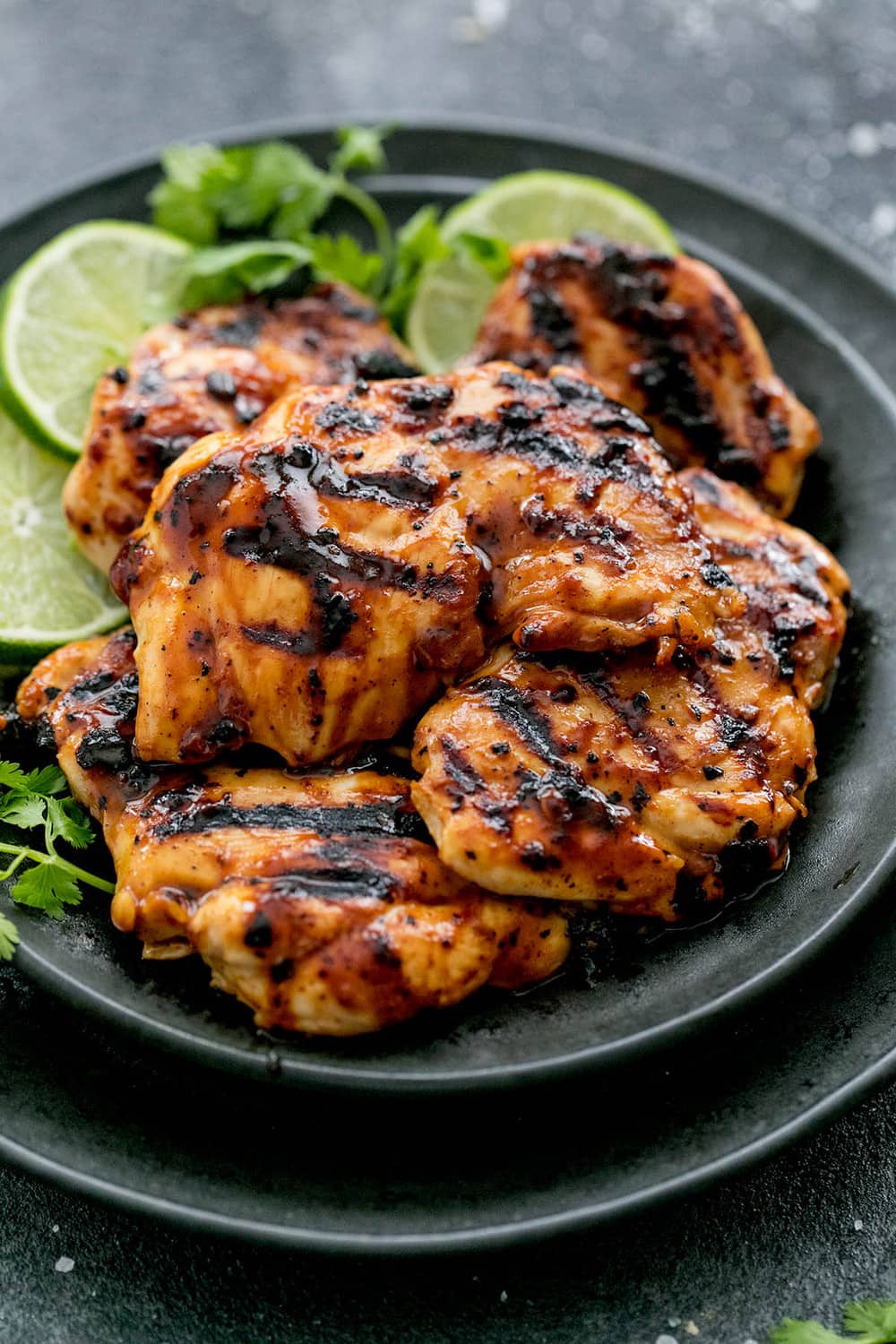 Grilled Chili Lime Chicken on a black plate.