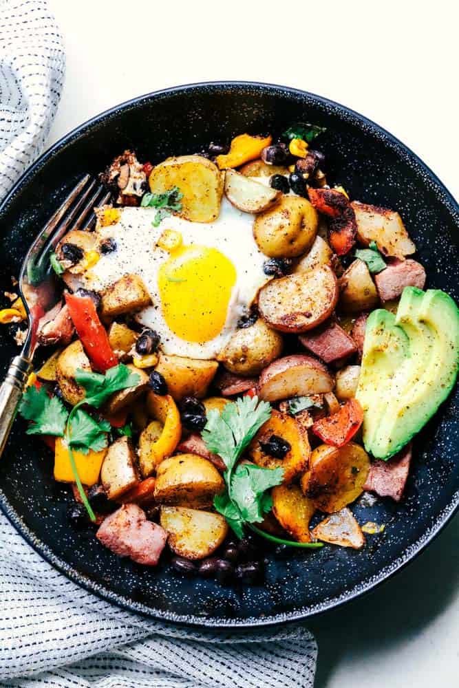 Southwest Baked Ham and Eggs Potato Hash in a skillet.