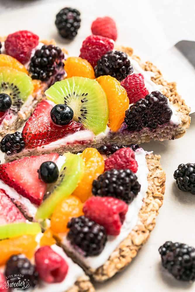 Fruit pizza cut into slices.