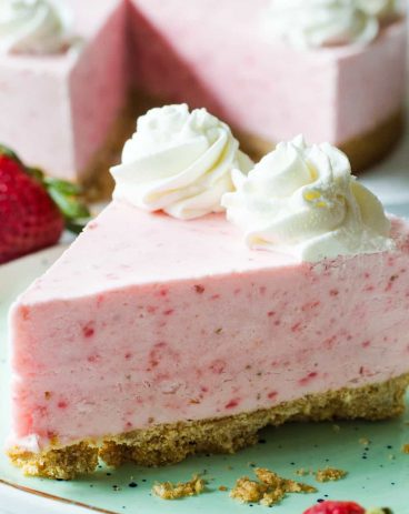 No Bake Frozen Strawberry Yogurt Pie! This frozen pie is perfect for warmer weather! No baking needed, and the pie itself is a creamy cool strawberry and cream flavor. Made with greek yogurt, real cream, and fresh strawberry puree! All on top of a pretzel crust.