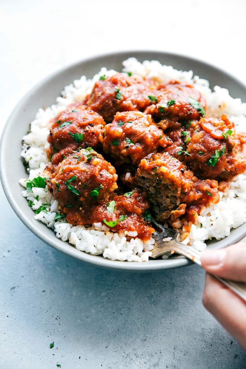 Slow Cooker Porcupine Meatballs on white rice and a gray bowl.