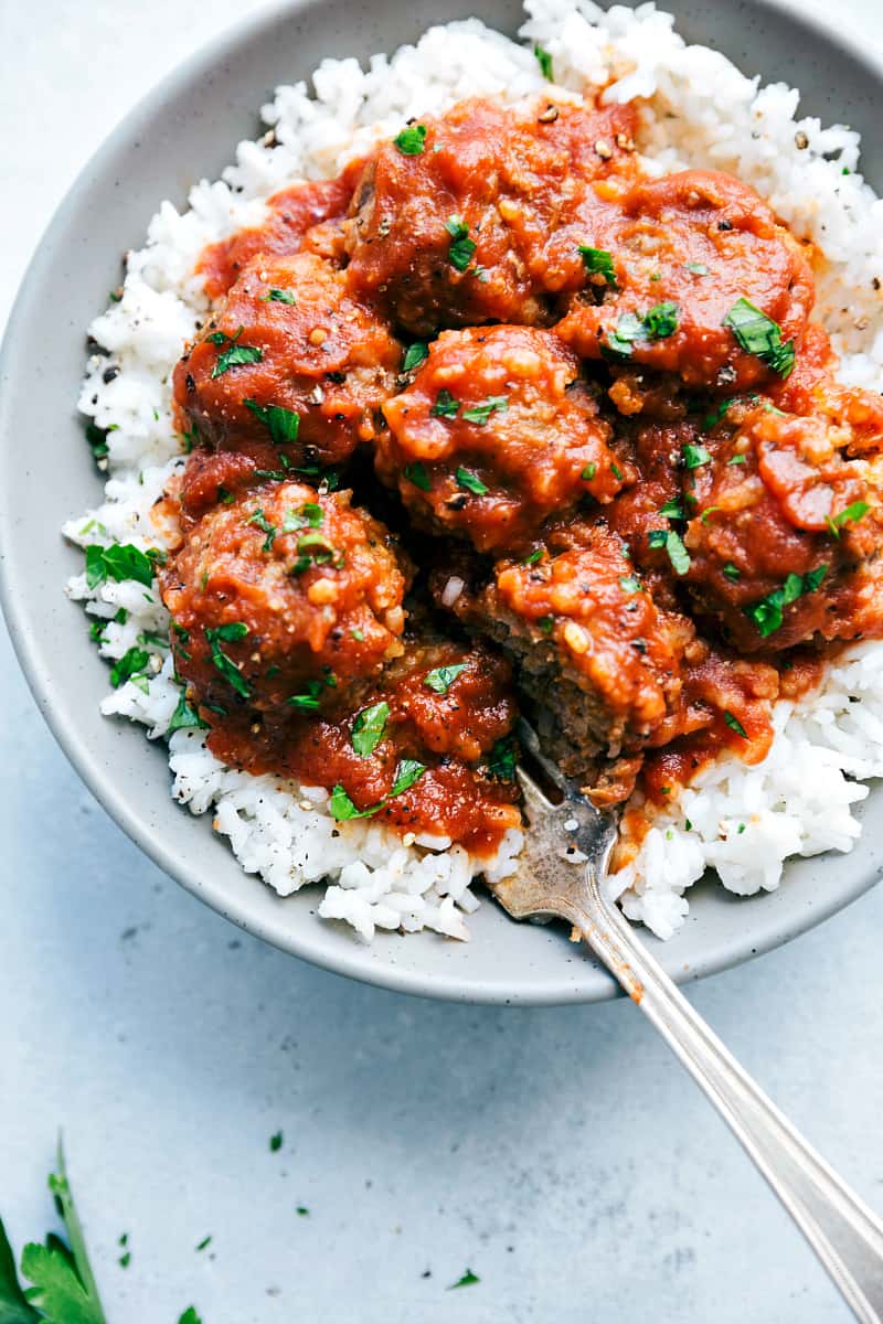 Slow Cooker Porcupine Meatballson rice in a gray plate.