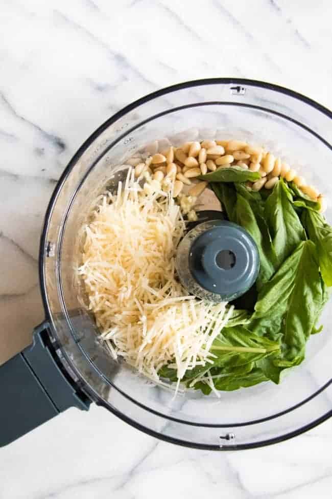 Pesto Pasta Salad ingredients in a food processor.