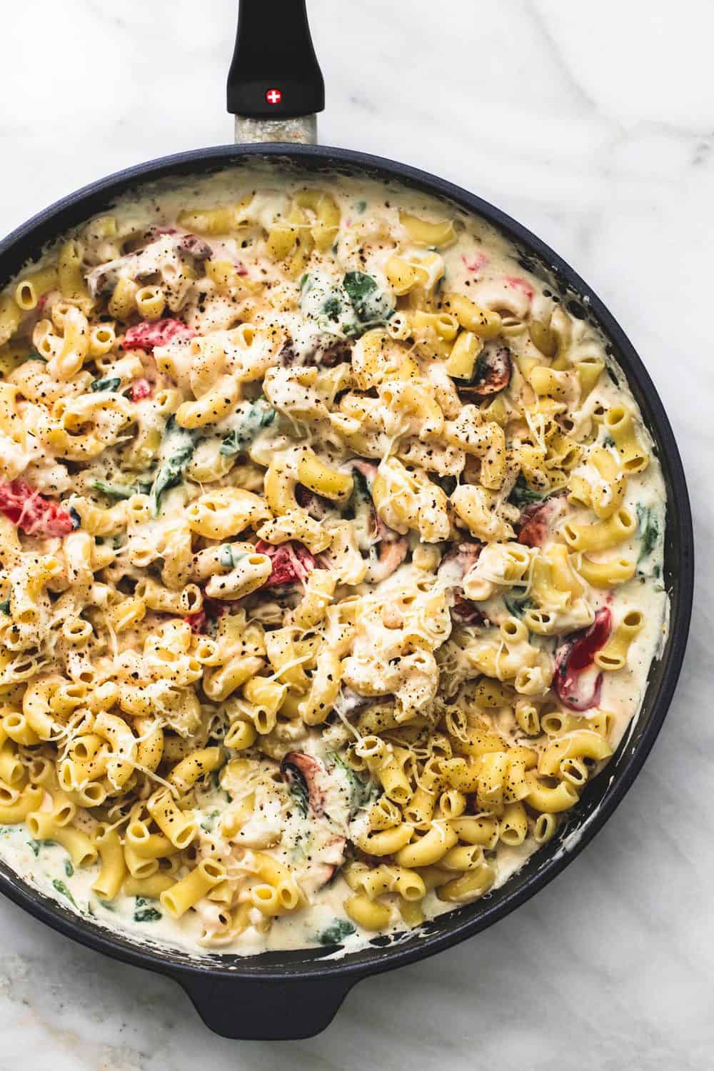 Baked Tuscan Parmesan Macaroni and Cheese in a black skillet.