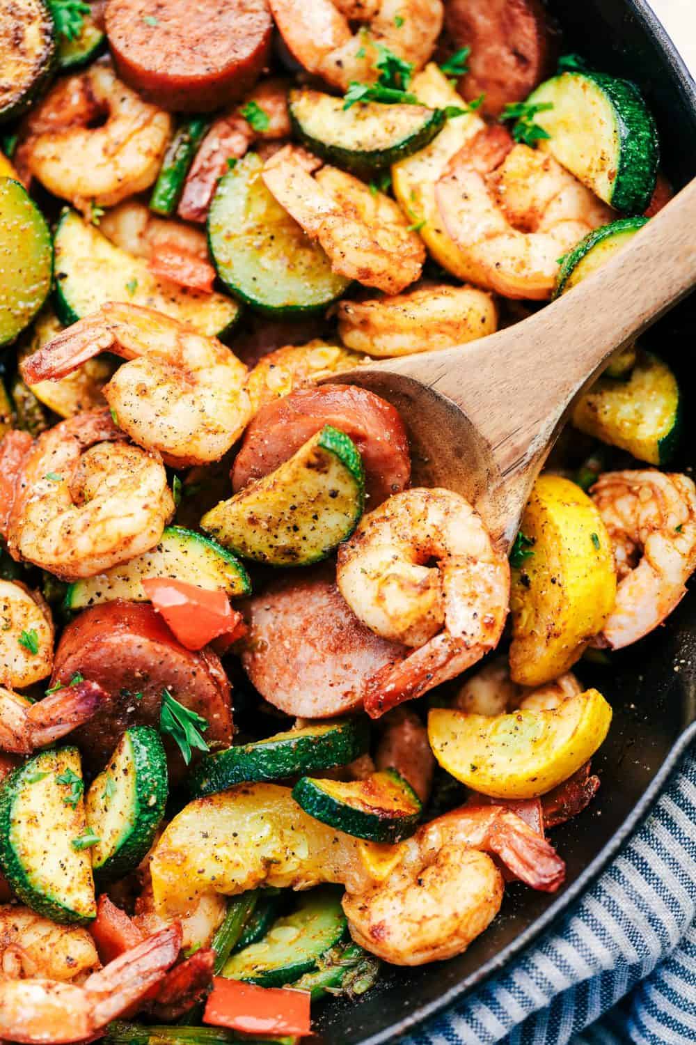 Cajun Shrimp and Sausage Vegetable Skillet with wooden spoon