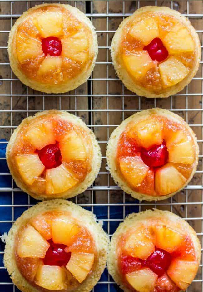 Easy, from-scratch, pineapple upside-down cupcakes on a cooling rack.