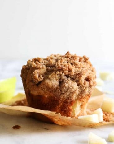 Apple Crumb Muffins.  Light and fluffy bakery style muffins loaded up with bits of fresh apple and spiced with a hint of cinnamon.  All topped off with a delicate brown sugar crumble. 