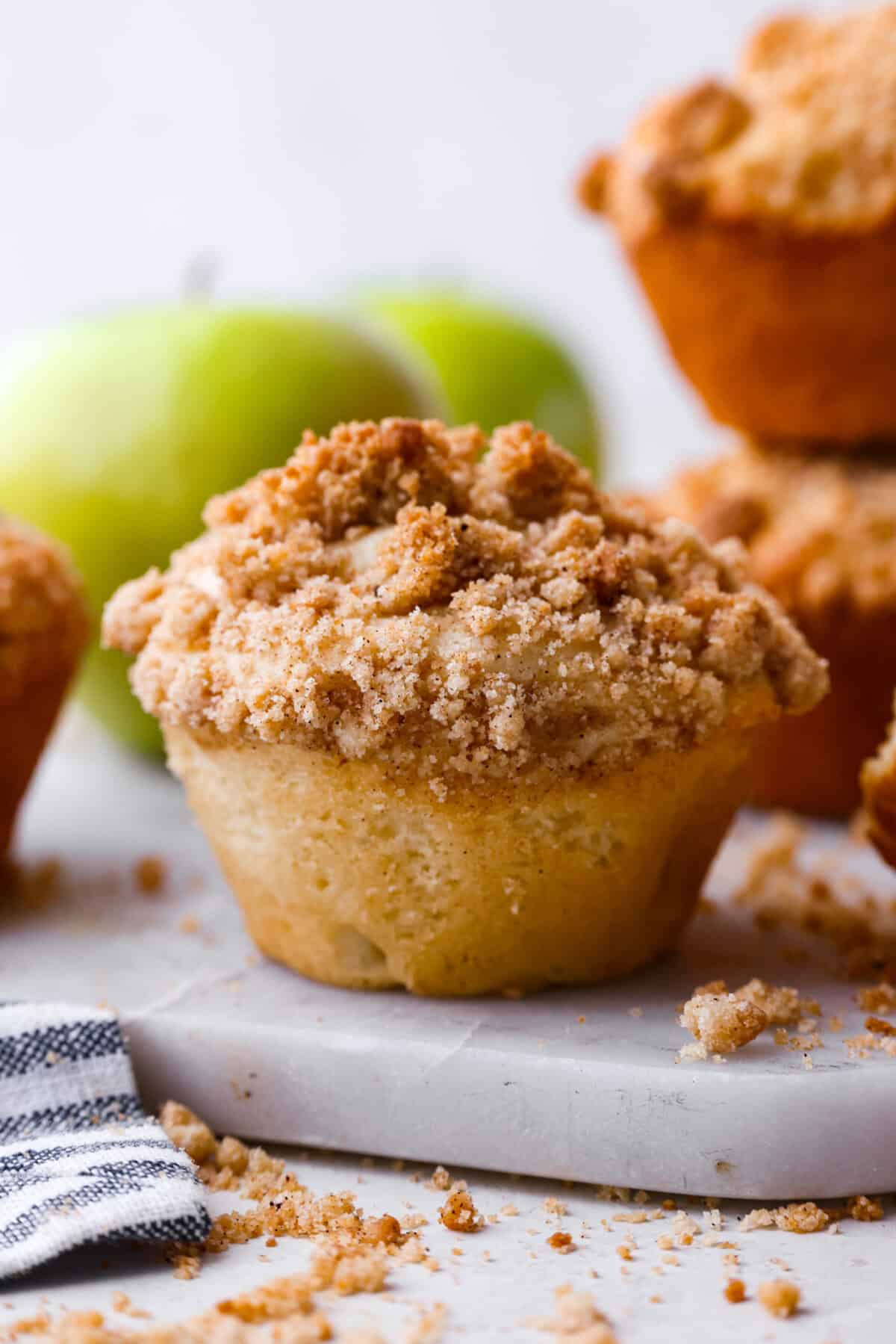 Close side view of an apple crumb muffin.