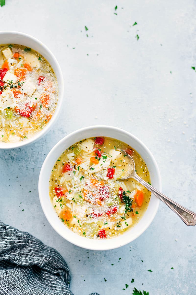 Hearty and delicious chicken and rice soup in a white bowl.