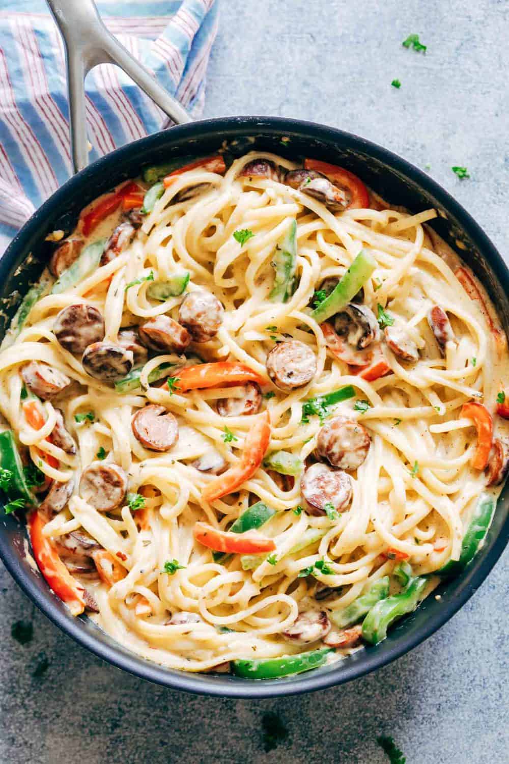 Creamy Cajun Sausage Linguine is a creamy 30 minute pasta recipe that's going to become a family favourite! Not too heavy on the cheese but still super creamy!