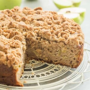 This Crumb-Topped Apple Coffee Cake is perfect for fall! Greek yogurt and extra apples keep it moist and a crunchy crumb topping gives it extra decadence!
