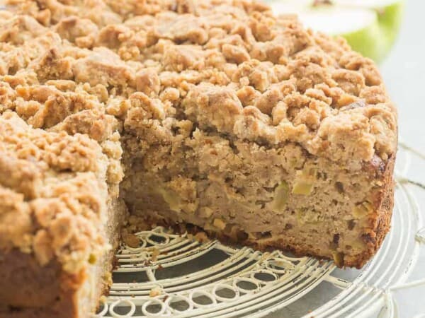 This Crumb-Topped Apple Coffee Cake is perfect for fall! Greek yogurt and extra apples keep it moist and a crunchy crumb topping gives it extra decadence!