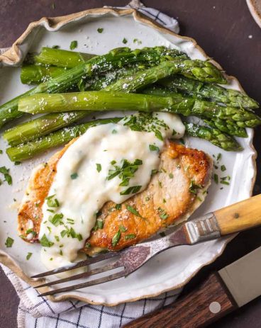 These Creamy Parmesan Pork Chops are sure to be a hit around the family table. The simple garlic parmesan sauce is oh so delicious and so easy anyone can make it in minutes. 