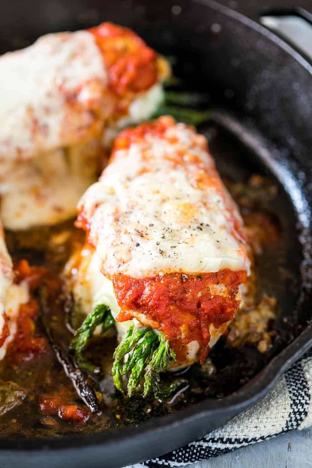 Asparagus Stuffed Chicken Parmesan is a easy, healthy dinner recipe that combines two of our favourites. Topped with marinara sauce and stuffed with cream cheese and asparagus, it’s keto friendly, low carb, gluten free and ready in 30 minutes. 