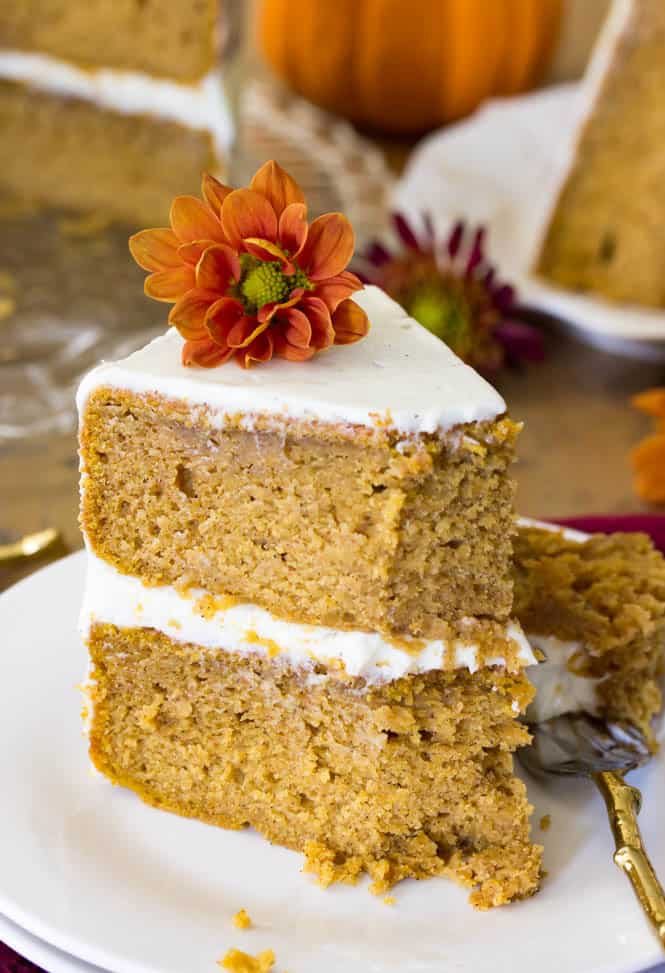 A slice of soft, moist, and EASY Pumpkin Cake, made from scratch and frosted with a simple, silky cream cheese frosting!