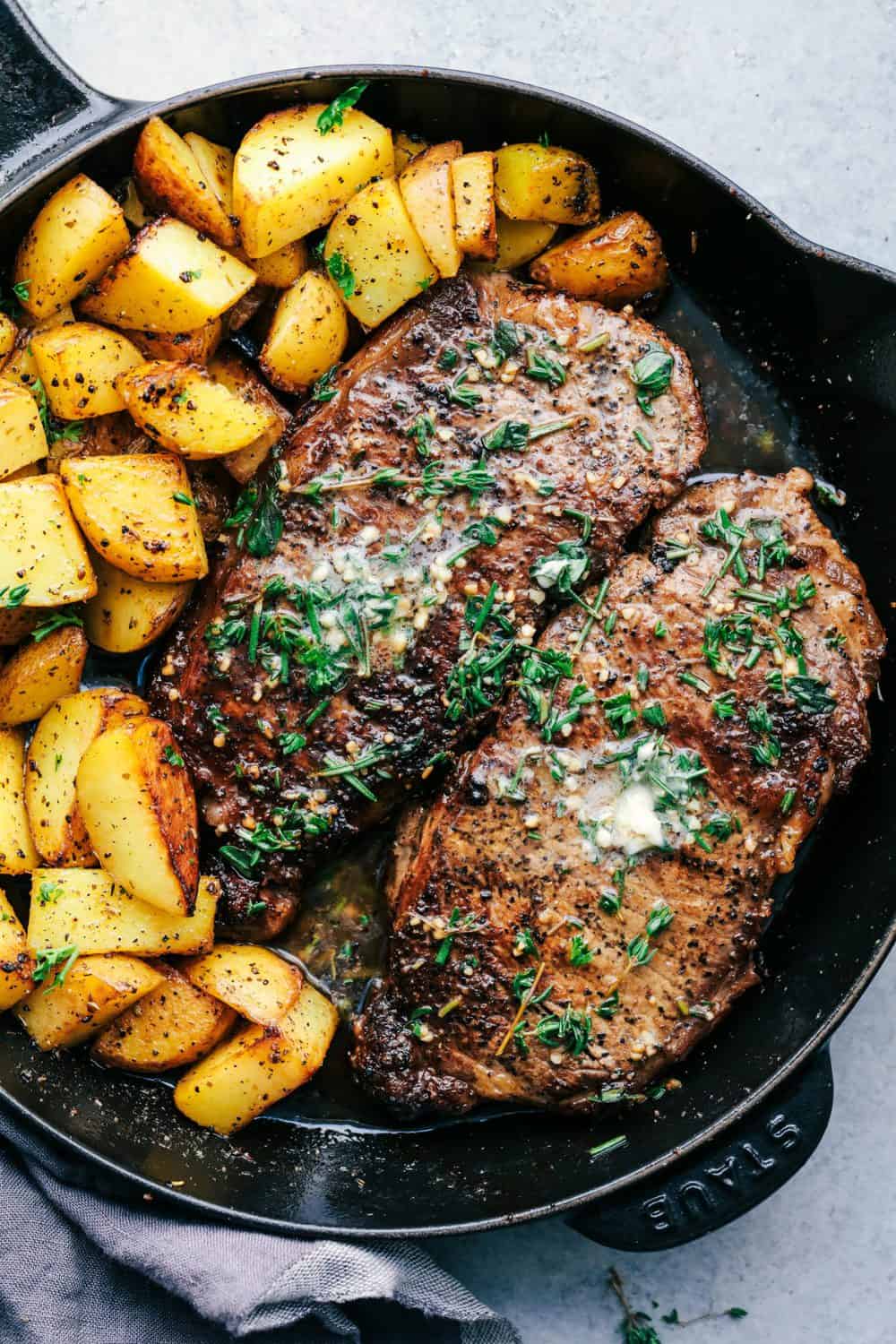 Skillet Garlic Butter Herb Steak and Potatoes in a skillet.