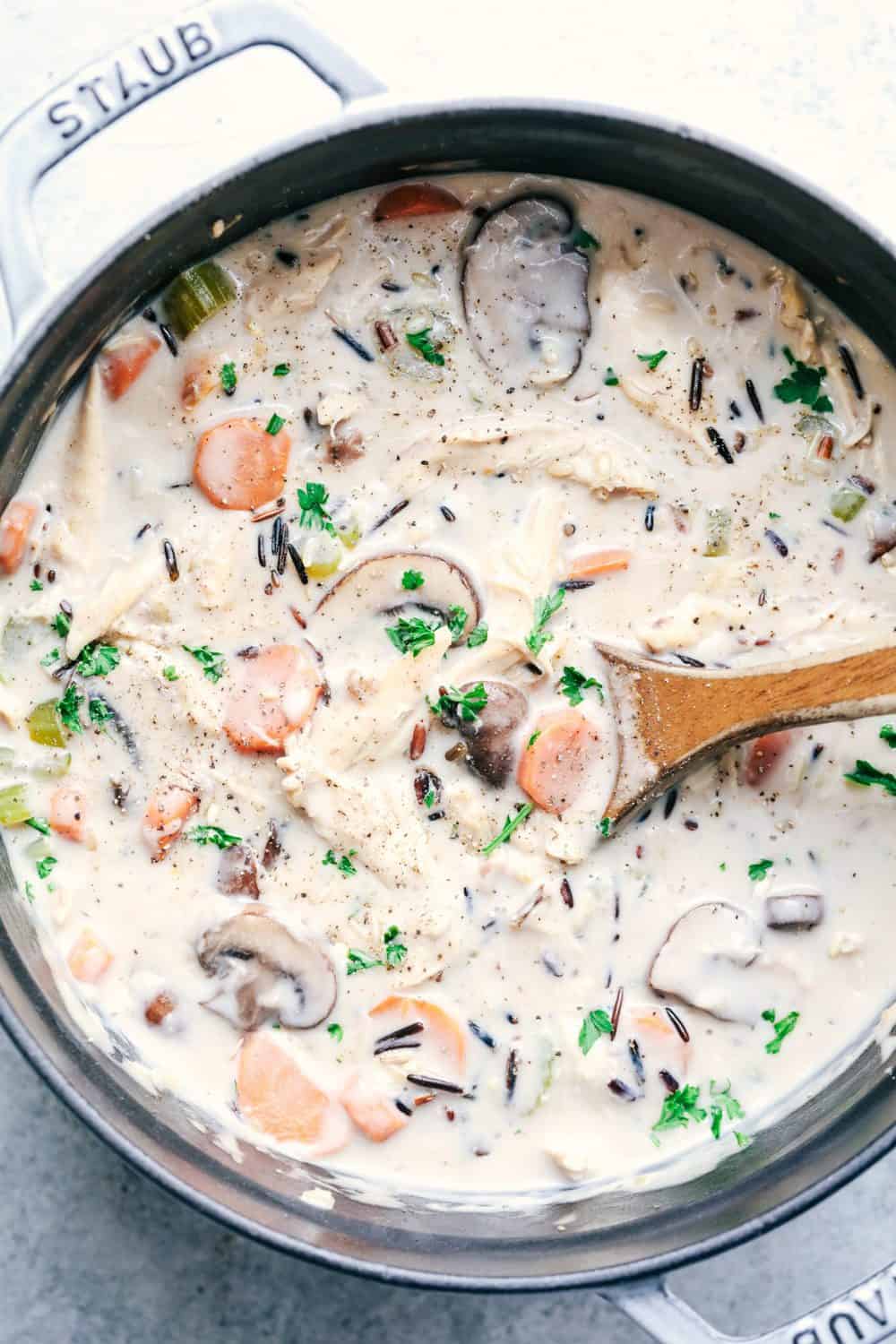 Creamy Turkey Wild Rice Soup in a pot with wooden spoon.