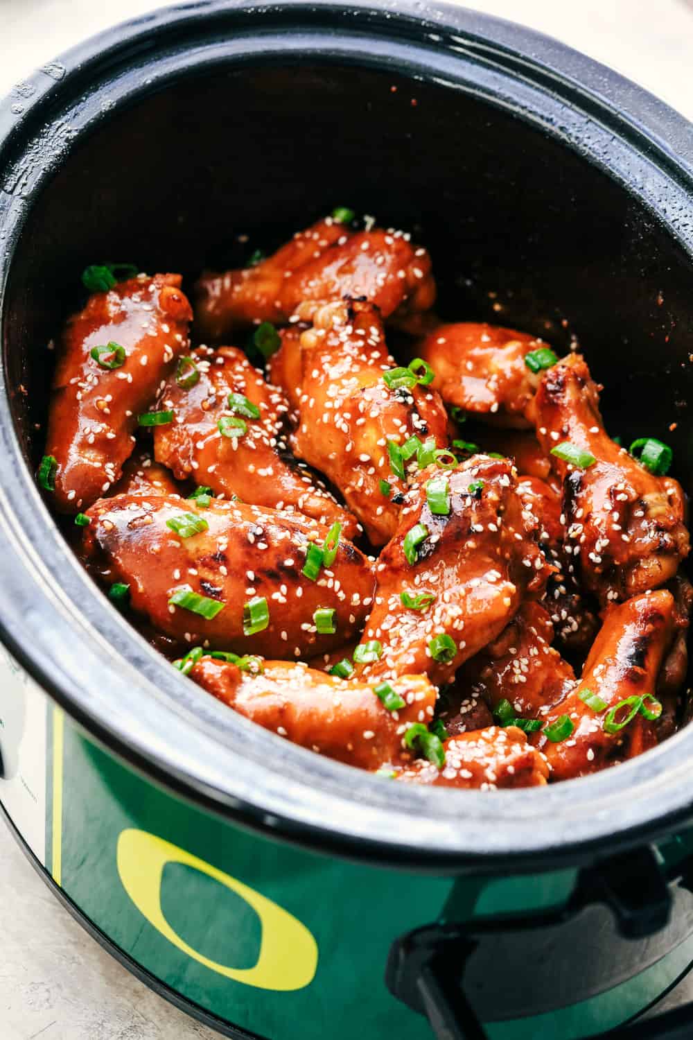 Slow Cooker Honey Garlic Sriracha Wings in a crock pot.