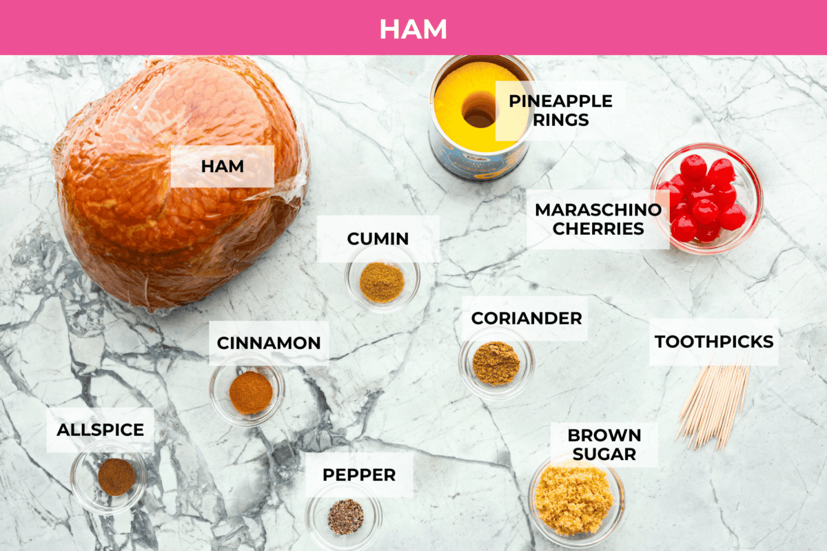 Brown Sugar Pineapple Glazed Ham is coated with a sweet and tangy spiced glaze that caramelizes on the edge of the ham. It's covered in juicy pineapple rings and maraschino cherries that add a tangy sweetness and juices to the succulent ham. Overhead shot of labeled ham ingredients.