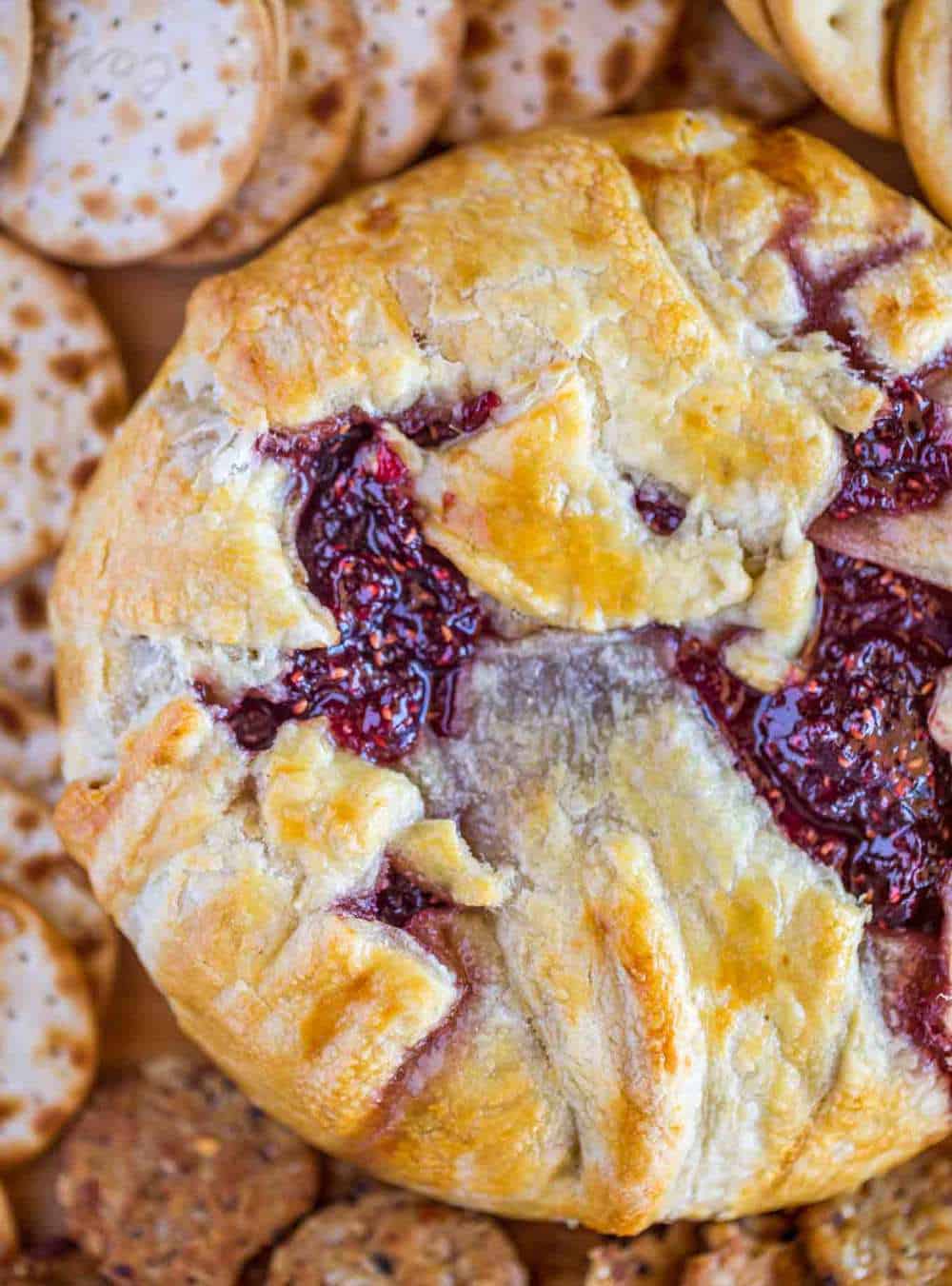 Raspberry Baked Brie is the perfect holiday appetizer with just FOUR ingredients. Perfect for Christmas and New Years Eve! 