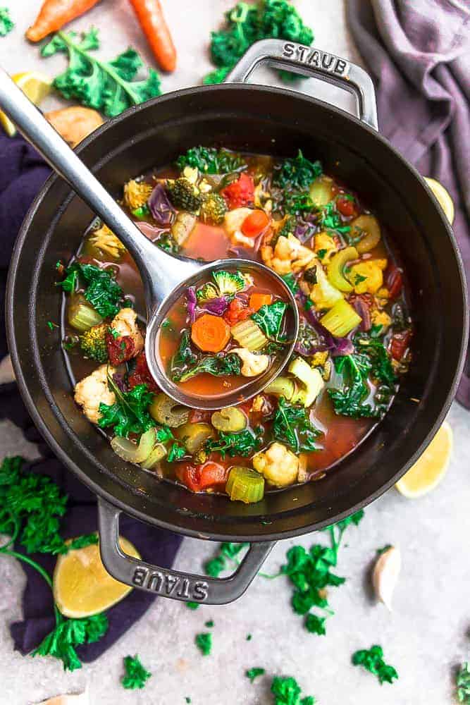 Vegetable detox soup in a pot with ladle 