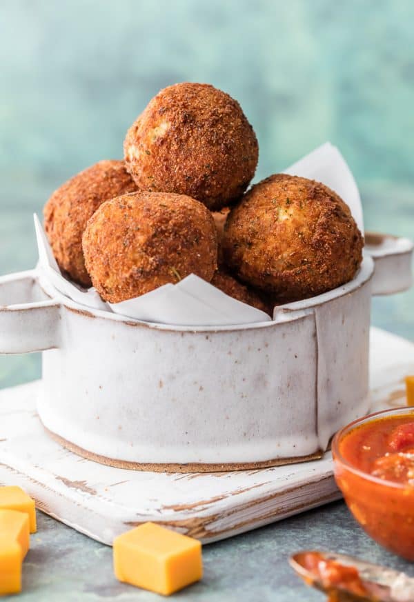 This Bacon Broccoli Cheese Arancini stacked in a pan.