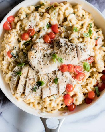 Chicken Caprese Mac and Cheese. A quick and easy one pot meal loaded with juicy chicken, cheesy pasta and fresh tomatoes and basil.