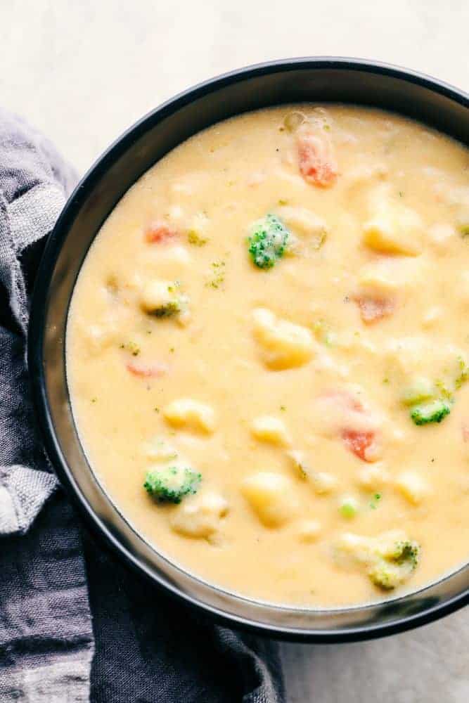 Cheesy Vegetable Soup in a black bowl.