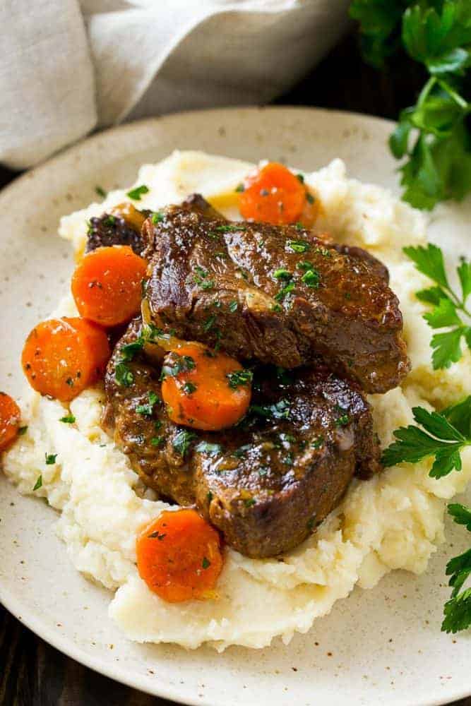 Root beer glazed short ribs and cooked carrots over mashed potatoes. 