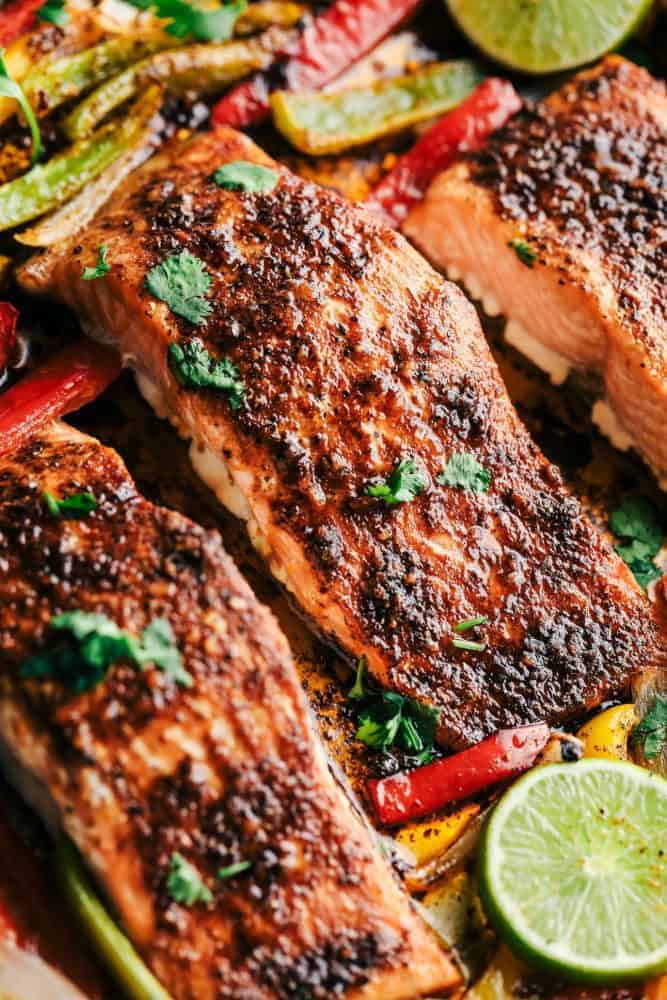 Sheet Pan Garlic Lime Salmon with lime and cut peppers.