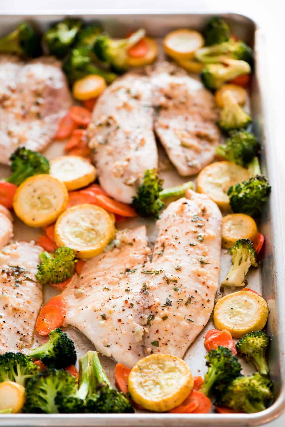 Baked Tilapia and Roasted Veggies on a pan