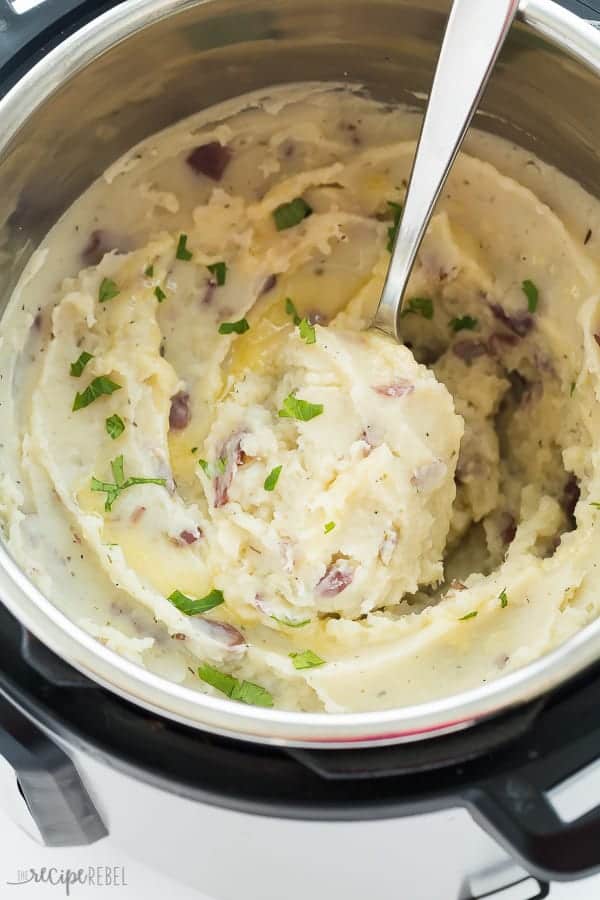 Mashed potatoes in an Instant Pot with a spoonful being scooped out. 