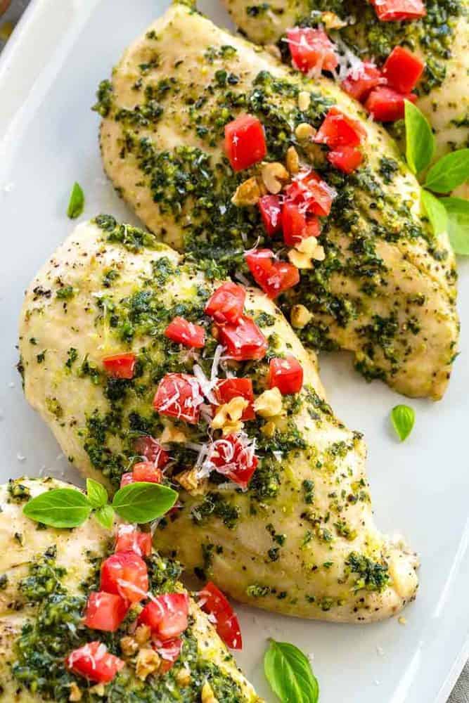 Pesto chicken breasts on a white serving plate