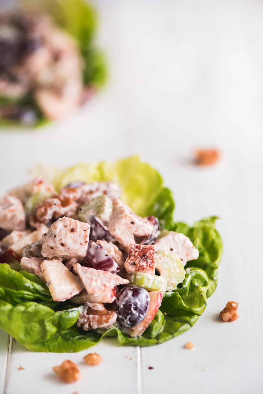 Waldorf Chicken Salad on a leaf of lettuce.