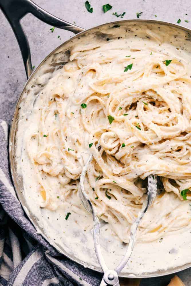 Asiago Garlic Alfredo Pasta in a pan with some tongs. 