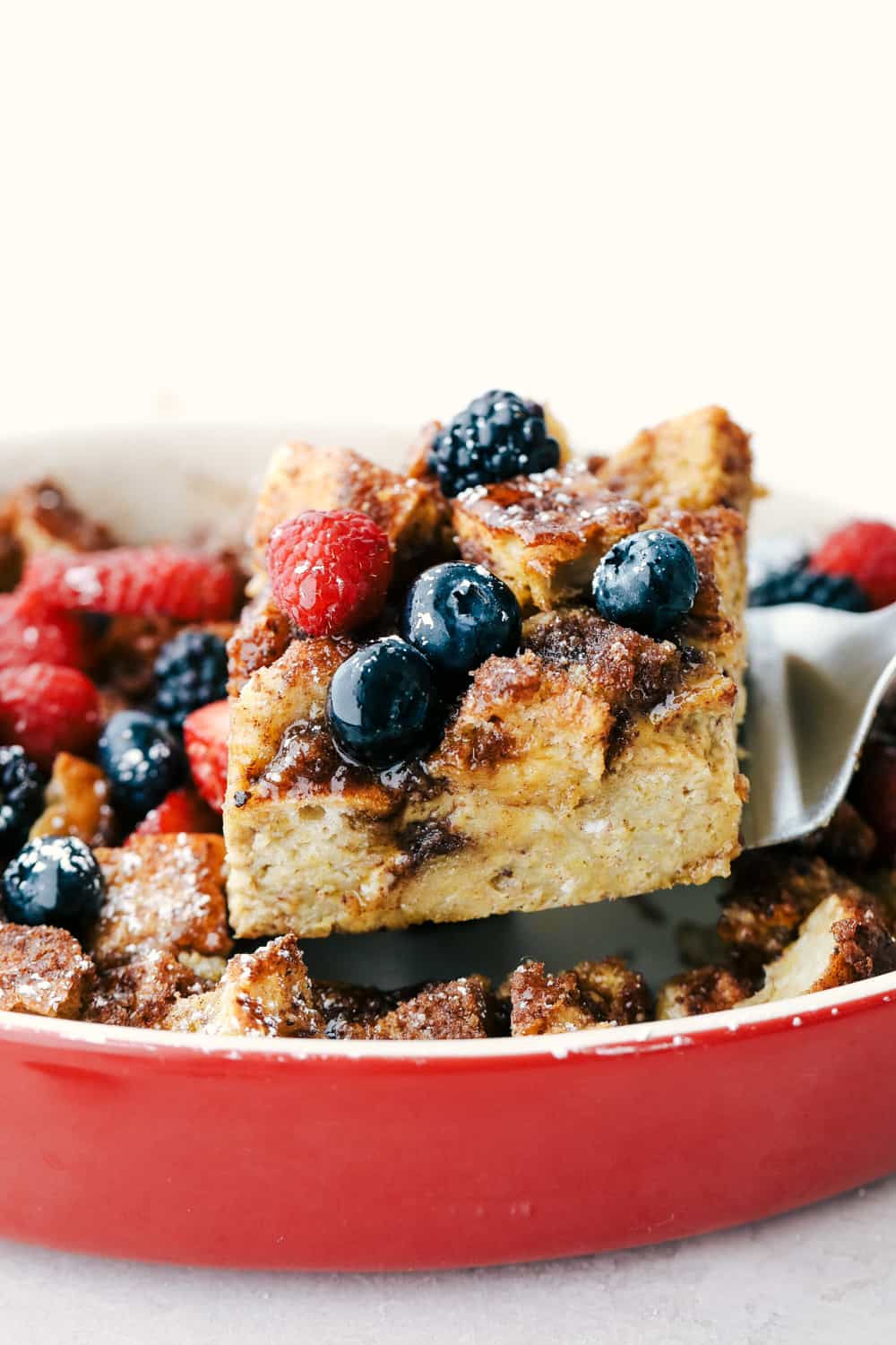 Close view of a spatula lifting baked French toast out of the pan.