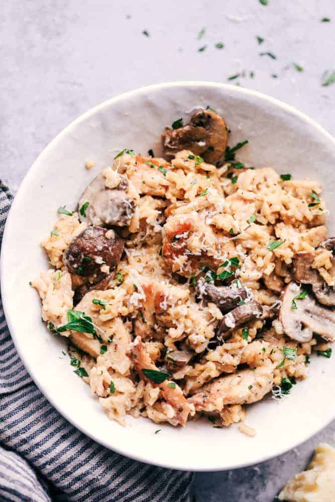 Creamy Parmesan Chicken with Mushroom Rice in a white bowl. 