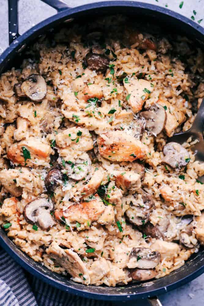 Creamy Parmesan Chicken with Mushroom Rice in a skillet. 