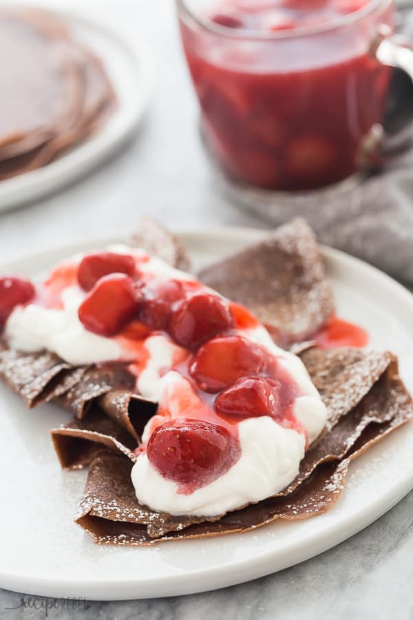 Chocolate crepes with whipped cream and strawberries.