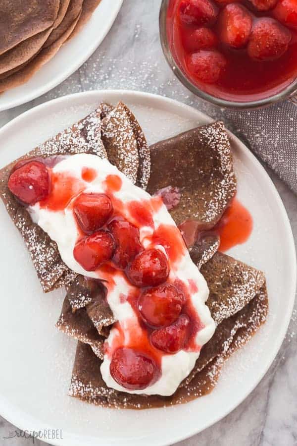 Chocolate crepes with strawberries and whipped cream.