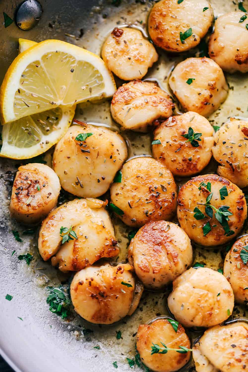 Scallops cooking in pan.