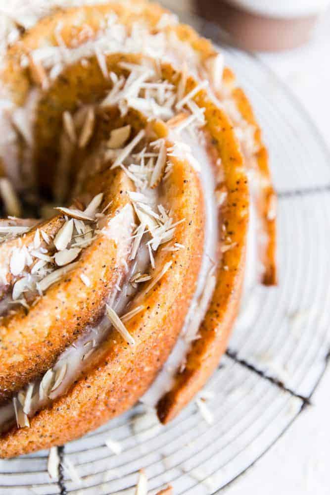 Close up of almond poppyseed bundt cake on a cooling rack. 