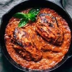 Creamy tomato basil chicken in a cast iron skillet ready to be served