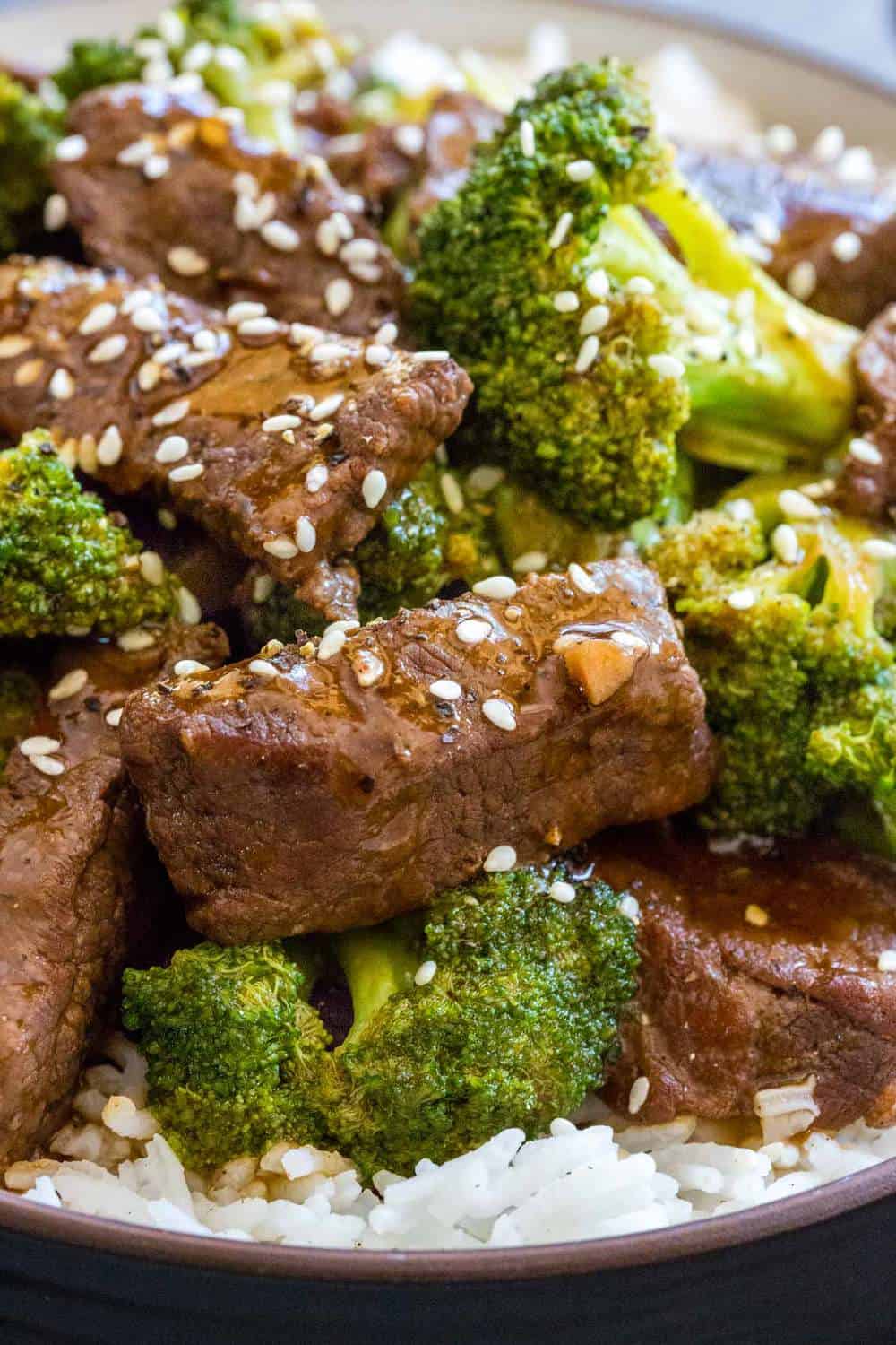 Close up photo of beef and broccoli topped with sesame seeds