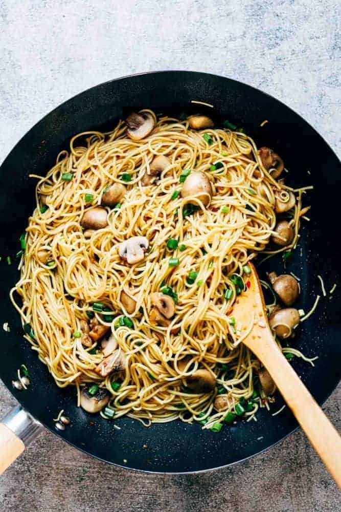 Garlic mushroom noodles tossed up in a wok.
