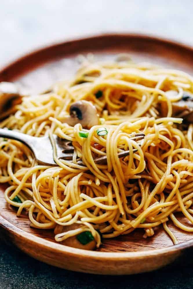 Garlic Mushroom Noodles served on a brown plate.