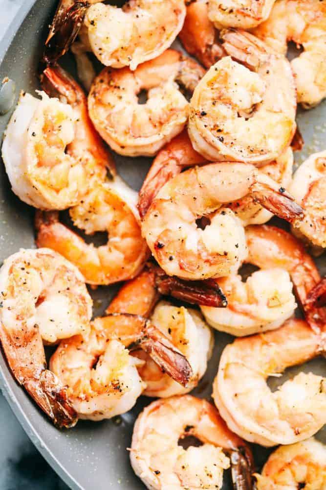 Shrimp being cooked in a sauce pan.